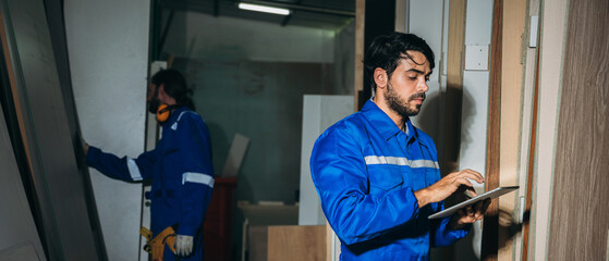 Professional Woodworker Measuring, Cutting and Installing Timber in Factory. Carpentry and Wood Manufacturing Process in Industrial Workshop