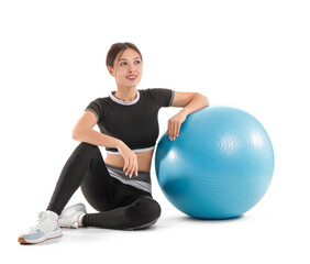 Fototapeta premium Sporty young Asian woman with fitball on white background