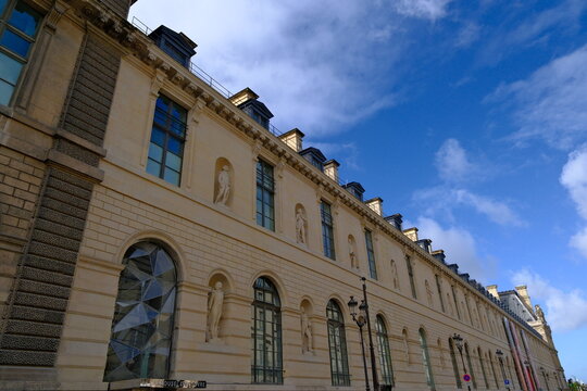Paris,France-Oct.4th 2025: classical facade of the Louvre Museum with decorative statues and niches.