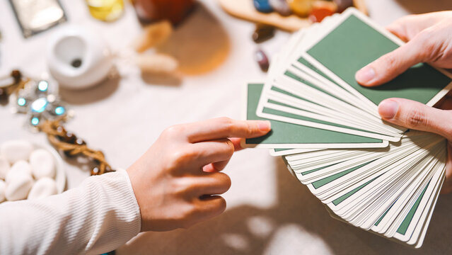 Fortune teller reading tarot cards using divine magic occultism
