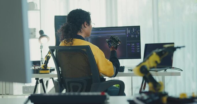Young Black female engineer coding AI robot arm in modern laboratory. Robotics, artificial intelligence, technology, stem, future, innovation, diversity, automation, machine learning concept.