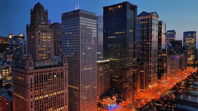 A cinematic drone shot of Chicago from over Lake Michigan at night, where the skyline glows with city lights reflecting across the dark water, creating a bold and dramatic aerial view.