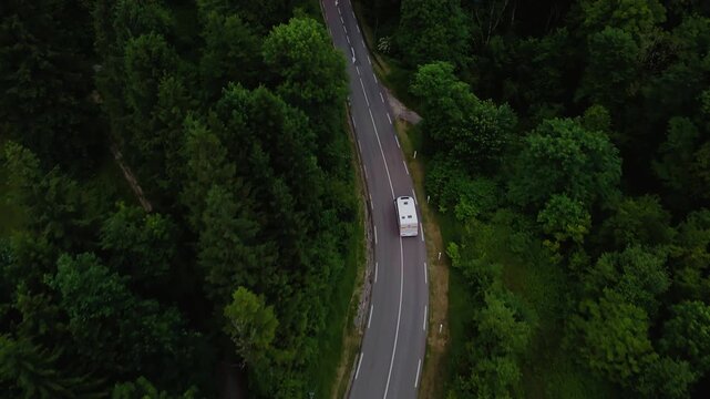 Cinematic Drone Follow of a Camper Van on a Winding Mountain Road in Alps, France