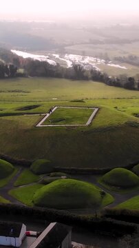 Neolithic Tomb Monument of Knowth, heritage and green landscape of Ireland. Drone vertical