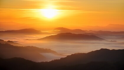 Obraz premium Golden Sunrise Over The Layered Mountain During Foggy Day