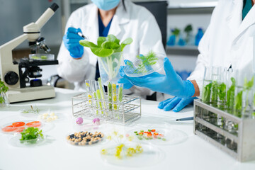 Food scientists in lab coats, testing samples, and analyzing food safety and quality in a modern...