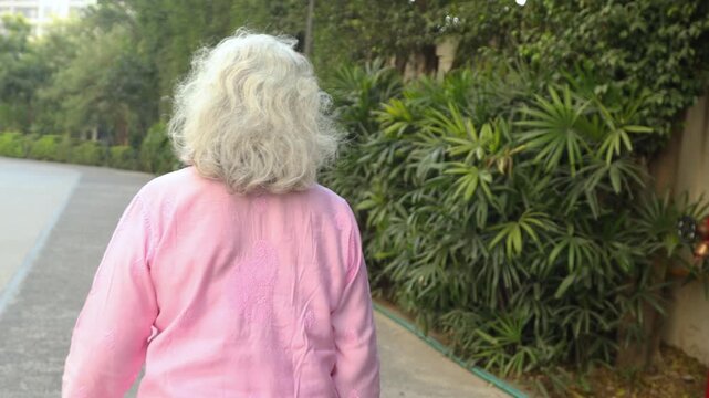 Happy retired senior indian elderly woman looking at camera do hello or hi outdoor. 4k