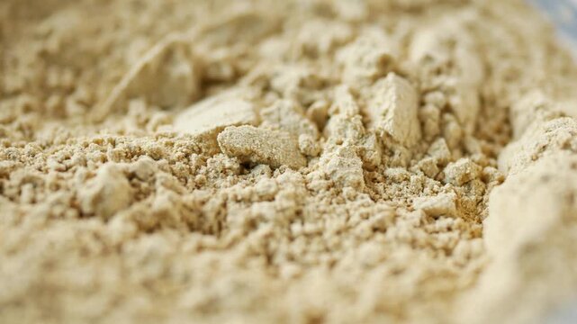 Close-up footage of protein powder texture, macro shot revealing fine particles and texture