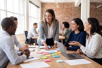 Obraz premium Cheerful diverse business team brainstorming ideas with sticky notes in a modern office meeting