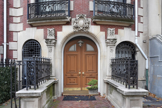 Entrance to ornate Manhattan townhouse with brown door