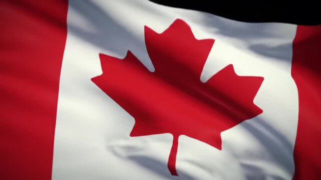 A close-up shot of a flag with a red maple leaf on a white background, waving in the wind. The flag is a symbol of a nation
