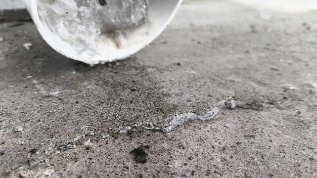 Cracked Concrete Surface with Crumbling Material and Bucket