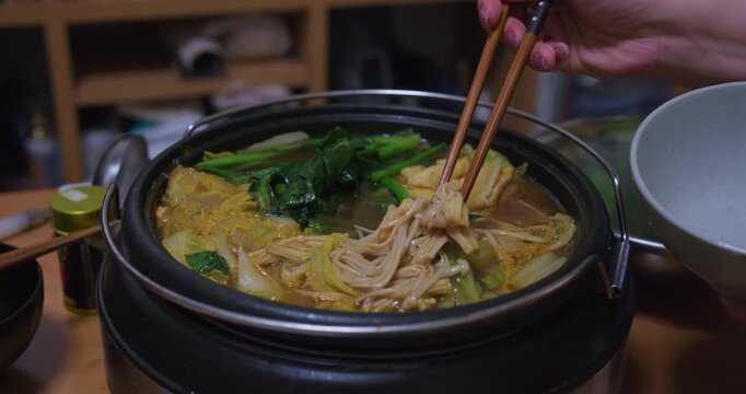 Serving Enoki Mushrooms from Boiling Japanese Nabe Hot Pot