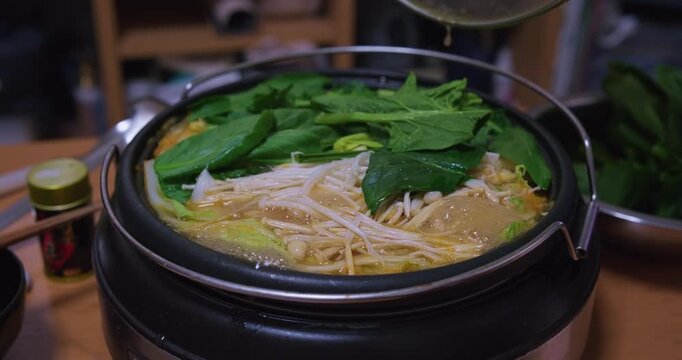 Lifting Lid Reveals Boiling Japanese Nabe Hot Pot