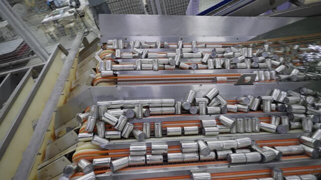 Canned food manufacturing industry, packaging cleaning process with cans passing through water sterilization according to international standards, operating on an automated conveyor machine in a proce
