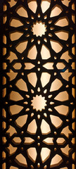 Close-up view of a geometric screen featuring intricate Islamic star patterns backlit by a warm, amber light.