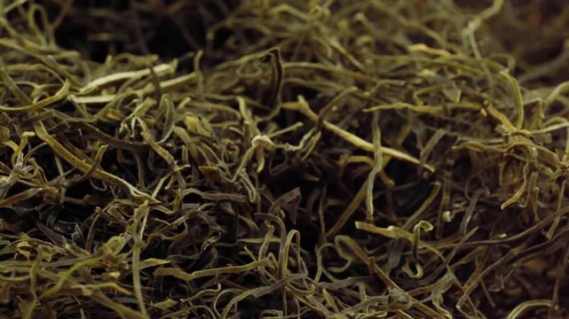 closeup macro dry chopped hidaka kelp or kizami hidaka kombu food texture background rotation turntable food video footage