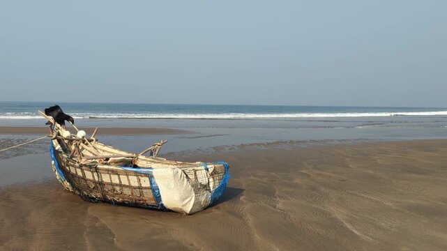 Static Wide Shot of a Weathered Fishing Boat Against a Clear Blue Sky and Horizon at cox's bazar