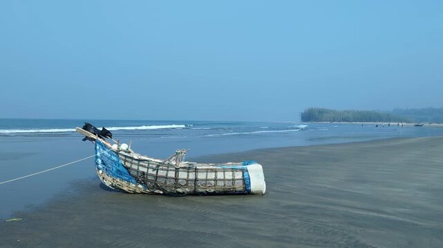 Traditional Artisanal Fishing Boat Resting on a Sandy Tropical Beach Shore at cox's bazar