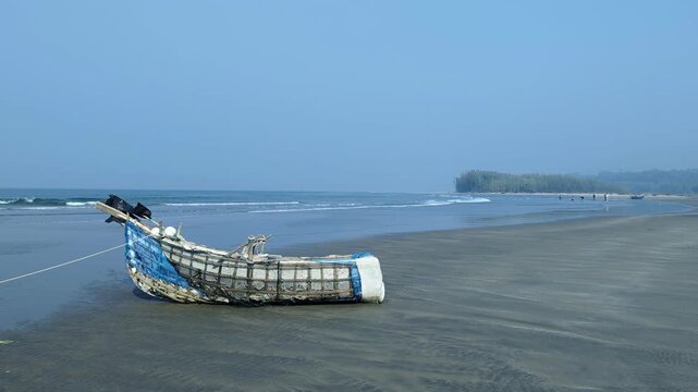 Traditional Artisanal Fishing Boat Resting on a Sandy Tropical Beach Shore at cox's bazar
