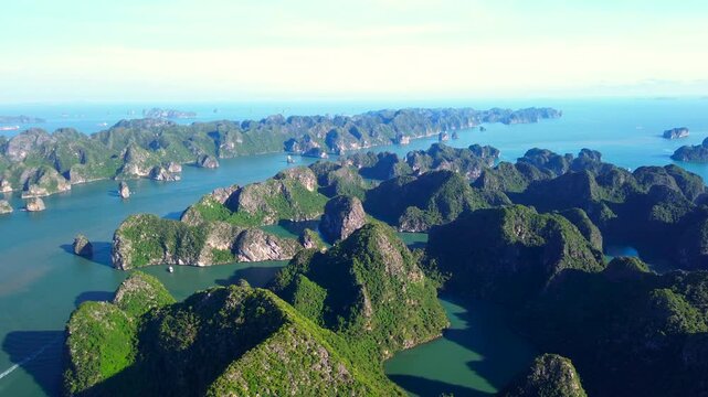 A sweeping high-altitude aerial panorama showcasing the vast horizon of Ha Long Bay, filled with countless lush limestone karst islands and calm emerald waters.