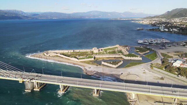 Drone aerial view of historic Patras Castle near Rio Antirrio bridge with coastline and sea in Greece