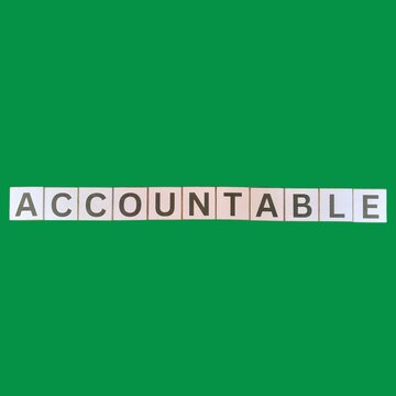 The word Accountable spelled on white letter tiles against a green background. Concept for responsibility, liability, business ethics, duty, trust, and transparency.