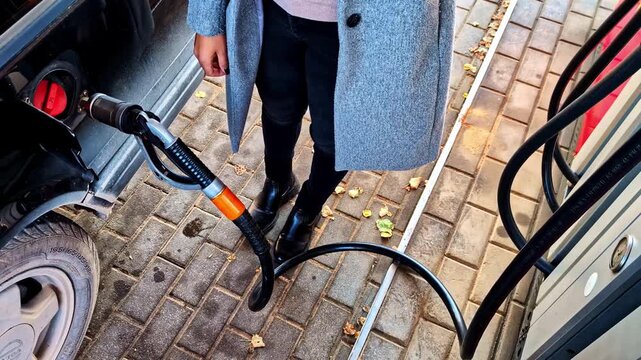 Person refueling a car at a gas station in Jelgava, Latvia