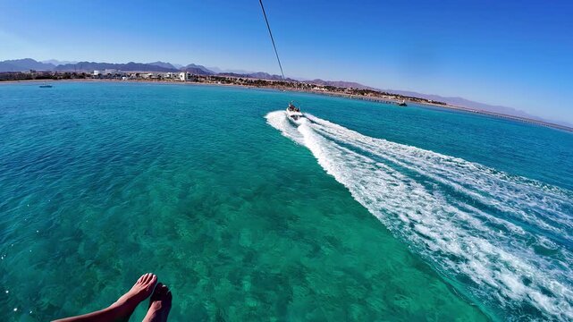 Aerial view of a parasailing adventure over crystal clear turquoise waters near Sharm El Sheikh Egypt