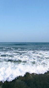 Serene Ocean Waves Crashing on Sandy Shore at Sunrise in Cox's Bazar