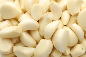 Fresh peeled garlic cloves as background, closeup