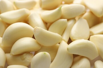 Fresh peeled garlic cloves as background, closeup