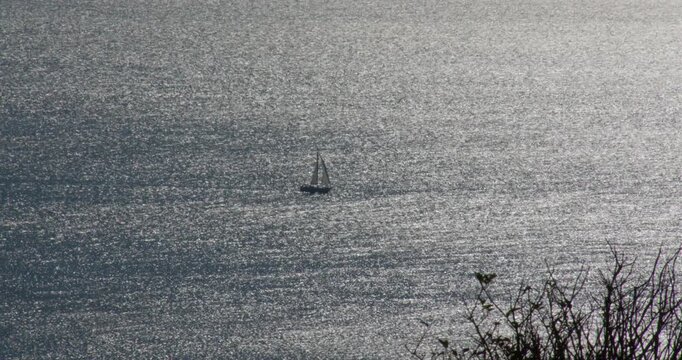 Silhouette Shot of a small sailboat in the English Channel from the cliffs by the abbot's Cliff sound mirror