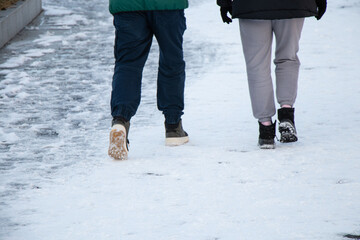 People walk along a snowy road in Ukraine, winter