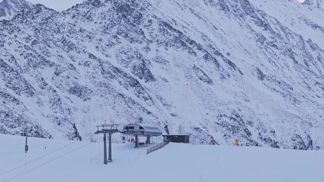 Drone footage capturing a parallax effect as the Krimml ski lift moves in the foreground, with snow-covered alpine mountains in the background, highlighting depth and dynamic winter scenery in Austria