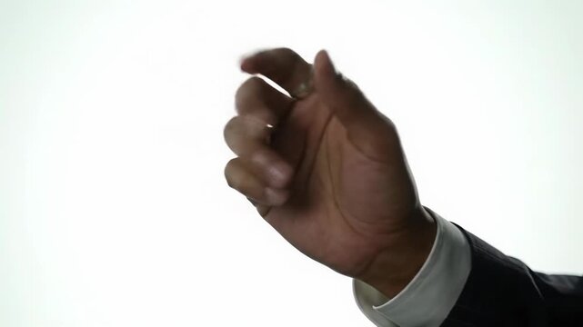 Close-up video of ethnically ambiguous hand in suit manipulating holographic interface with precise gestures on a seamless white background, soft bokeh. Concept of digital innovation