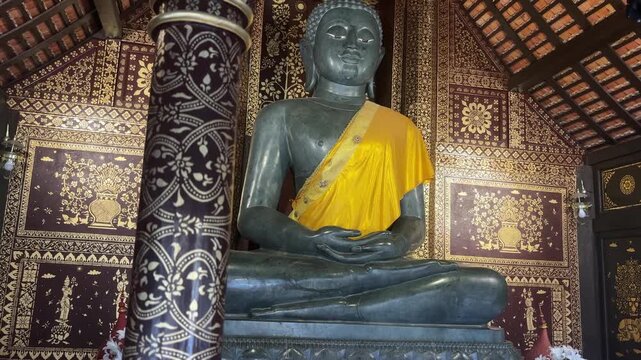 Large seated Buddha statue inside Wat Phra Singh temple with ornate decorative interior and traditional architecture spiritual scene Chiang Mai Thailand