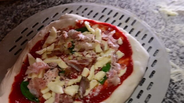 Close-up of professional chef preparing and baking italian pizzas in oven