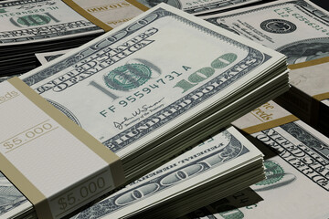 several stacks of one hundred US dollar bills bound with paper bands. Concept of wealth, cash savings, banking success, and large financial transactions in a dark setting.
