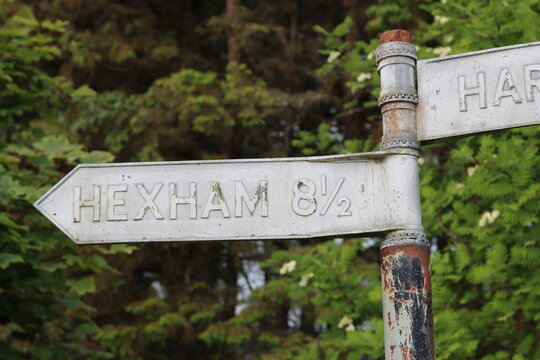 Old metal road sign, pointing to Hexham, Northumberland