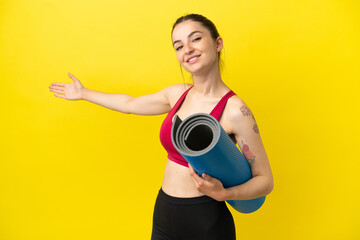 Young sport woman going to yoga classes while holding a mat extending hands to the side for...