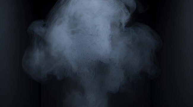 Mysterious billowing fog rises up from a dark abstract corner location