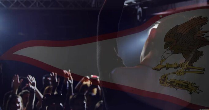 Concert singer entering stage singing into mic, engaging crowd as flag overlay drifting obscuring