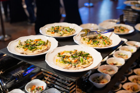 Luxury buffet with gourmet appetizers at upscale conference or wedding reception, elegant catering service with stylish presentation, glamorous high end event atmosphere