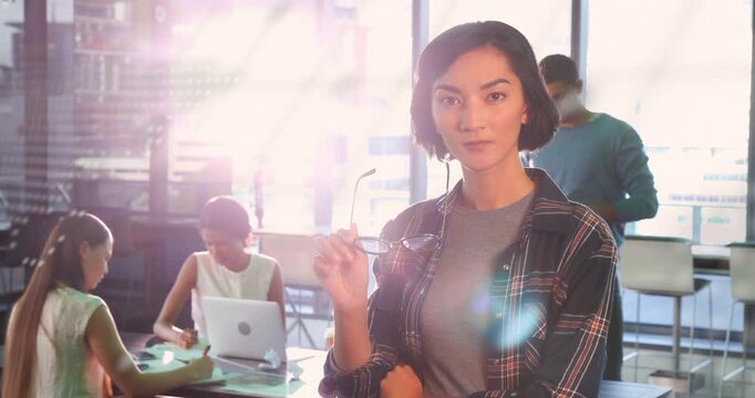 Foreground woman removing glasses after overlay shift, presenting tech concept with globe and code