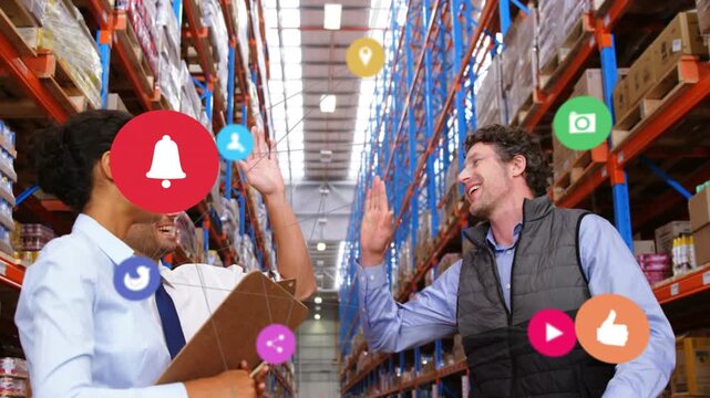Warehouse team checking clipboard and box, icons appearing and leading highfive celebrating orders
