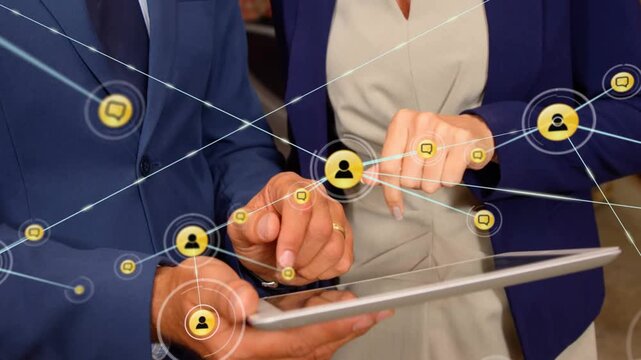 Man supporting tablet, woman tapping and activating growing network nodes on tablet for business