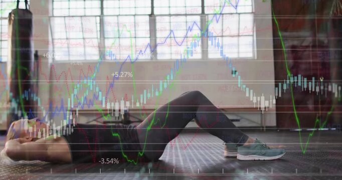 Woman doing core crunches on gym floor, starting seated for core, with finance charts overlaying
