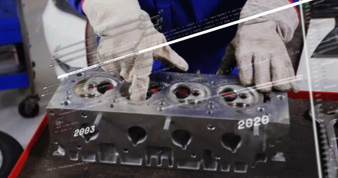 Gloved hand reaching to block hands inspecting cylinder head on bench in auto workshop HUD sweeping