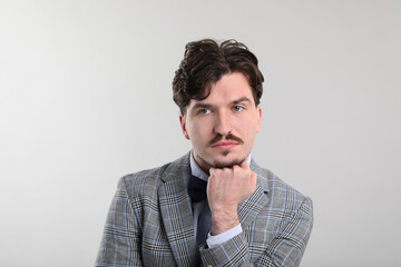 Obraz premium Handsome man with mustache on light background